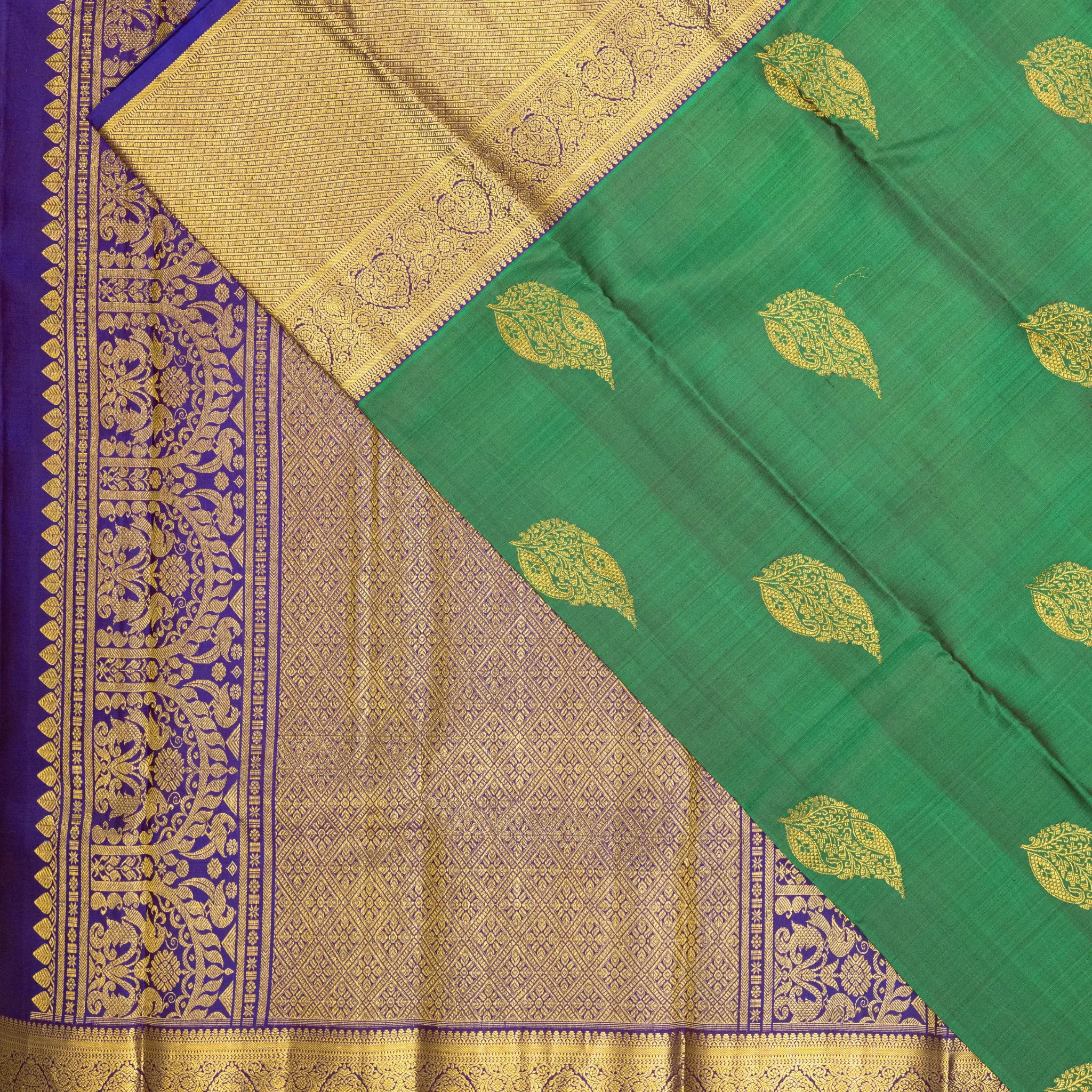 Emerald Green Kanchipuram Silk Saree – Gold Paisley Buttas with Royal Blue Zari Border
