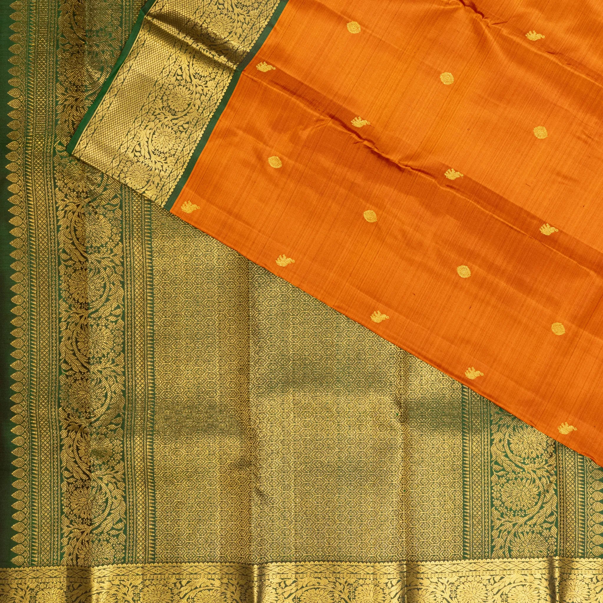 Mustard Orange Kanchipuram Silk Saree – Gold Zari Buttas with Green Floral Border